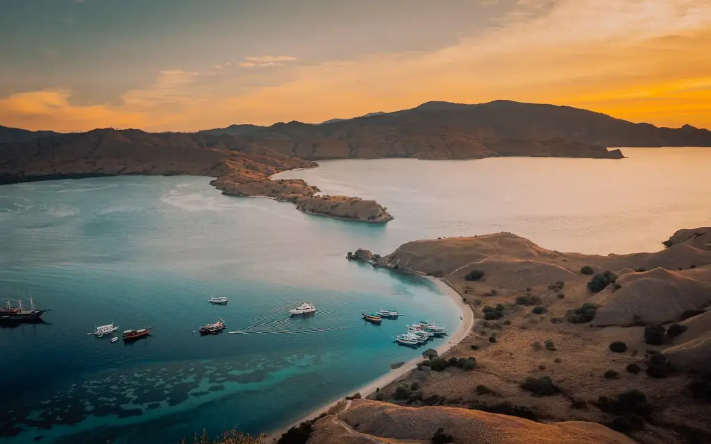 Golden late-afternoon light over the bay and bare ridges of Gili Lawa, Komodo National Park.