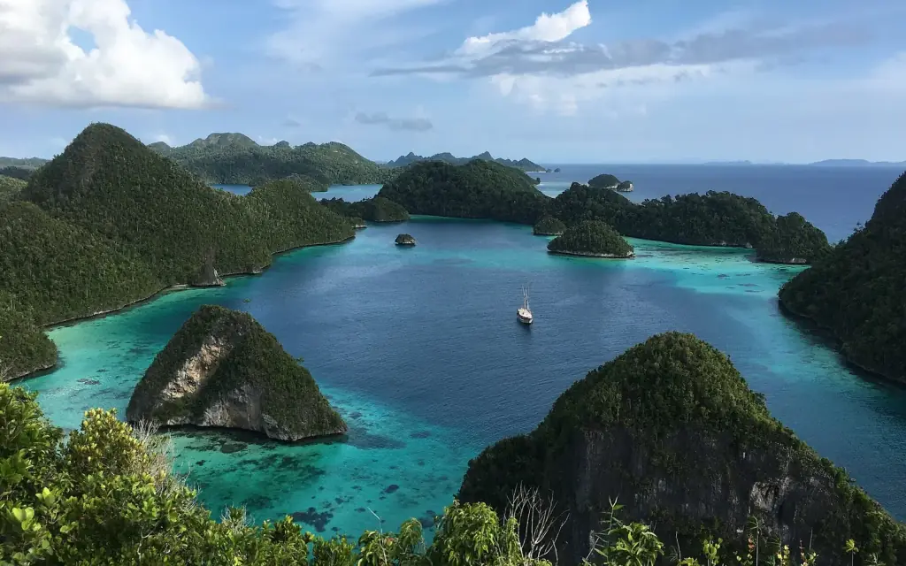 Forested limestone islets and turquoise channels at the Wayag atolls, Raja Ampat, West Papua.