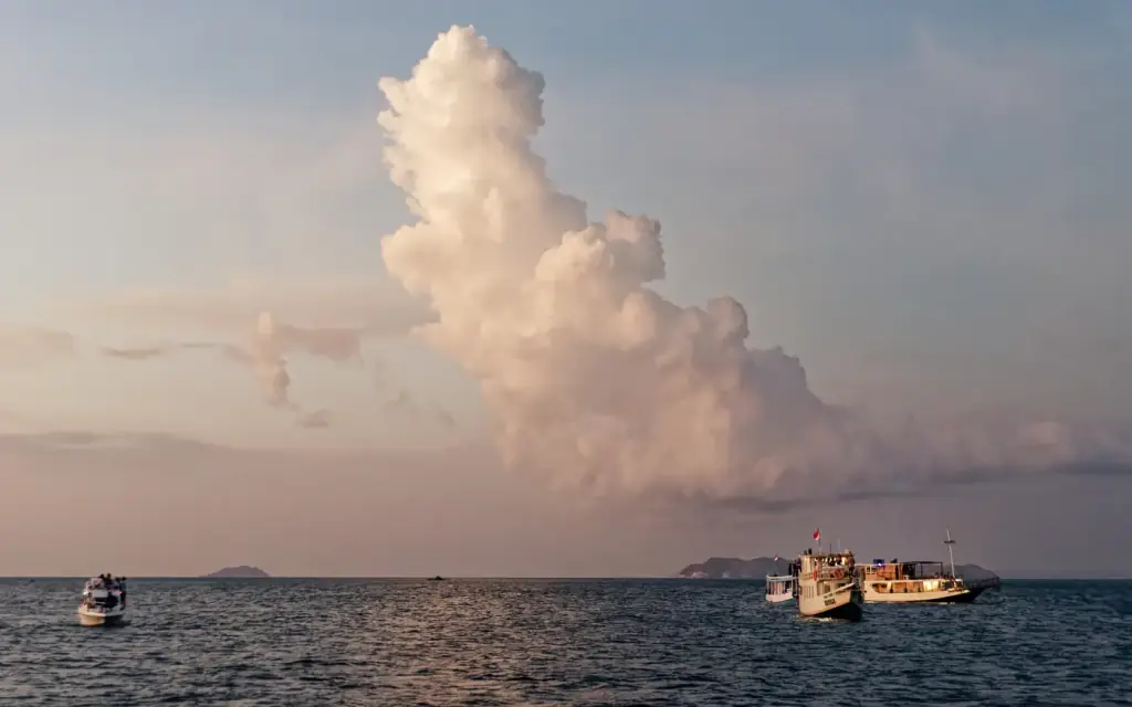 Boats on the water near Koabe Island at dusk, Komodo National Park.