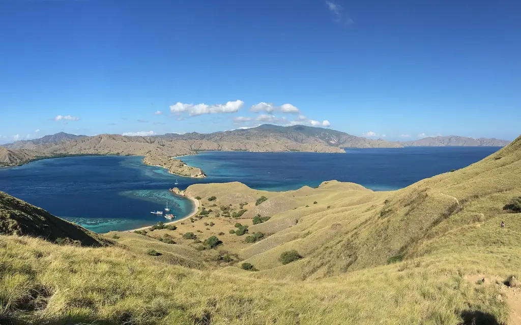 The green hills and deep sheltered bay of Gili Lawa seen from the ridge, Komodo National Park.